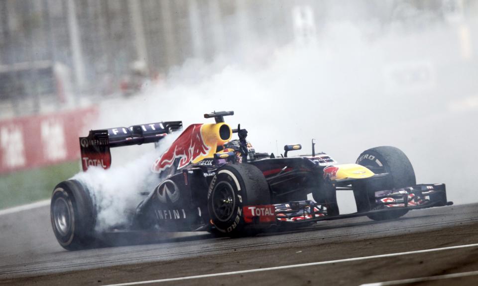 Red Bull Formula One driver Vettel does a burnout to celebrate winning the Indian F1 Grand Prix at the Buddh International Circuit in Greater Noida