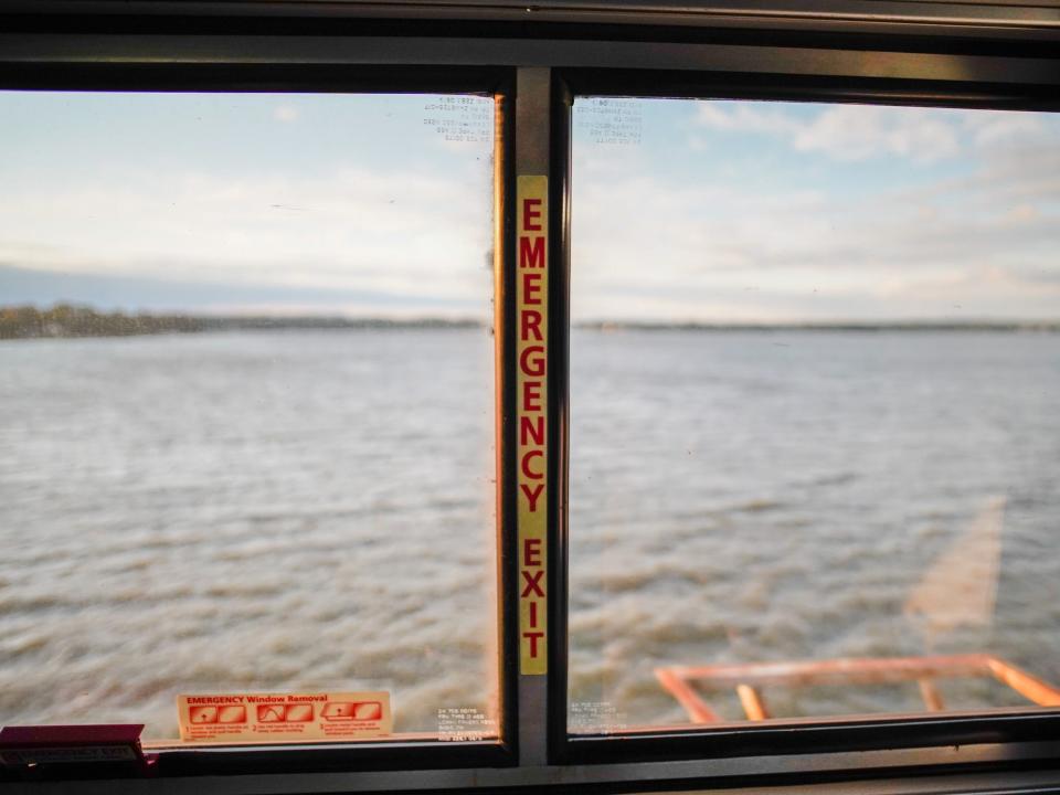 A view of a body of water out the train window in the Amtrak Roomette