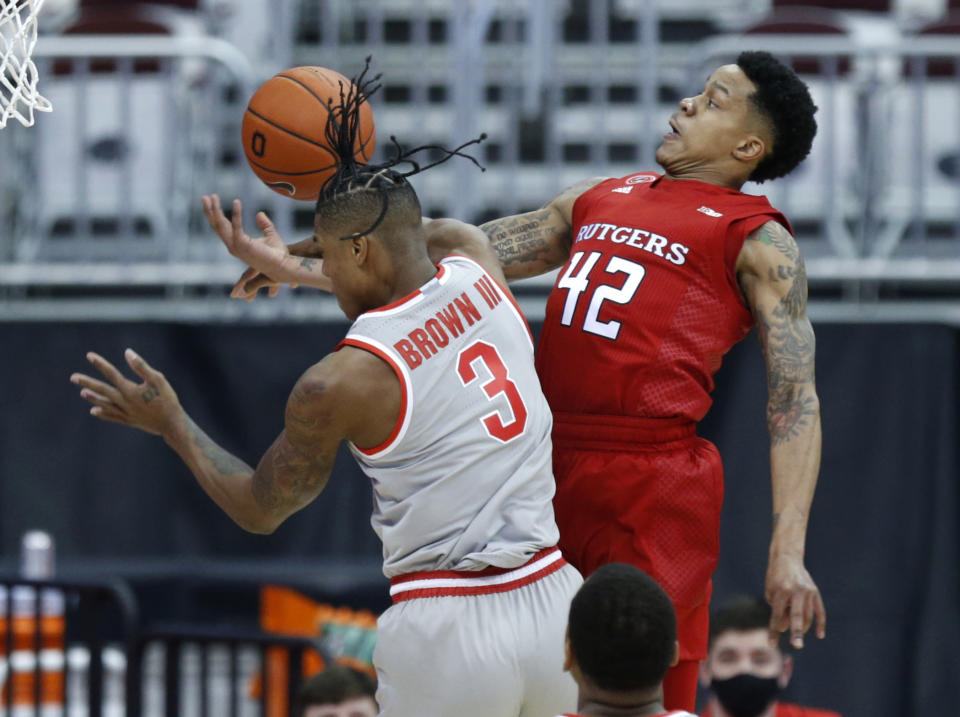 Rutgers guard Jacob Young, right, is fouled as he goes up for a shot against Ohio State guard Eugene Brown during the first half of an NCAA college basketball game in Columbus, Ohio, Wednesday, Dec. 23, 2020. (AP Photo/Paul Vernon)