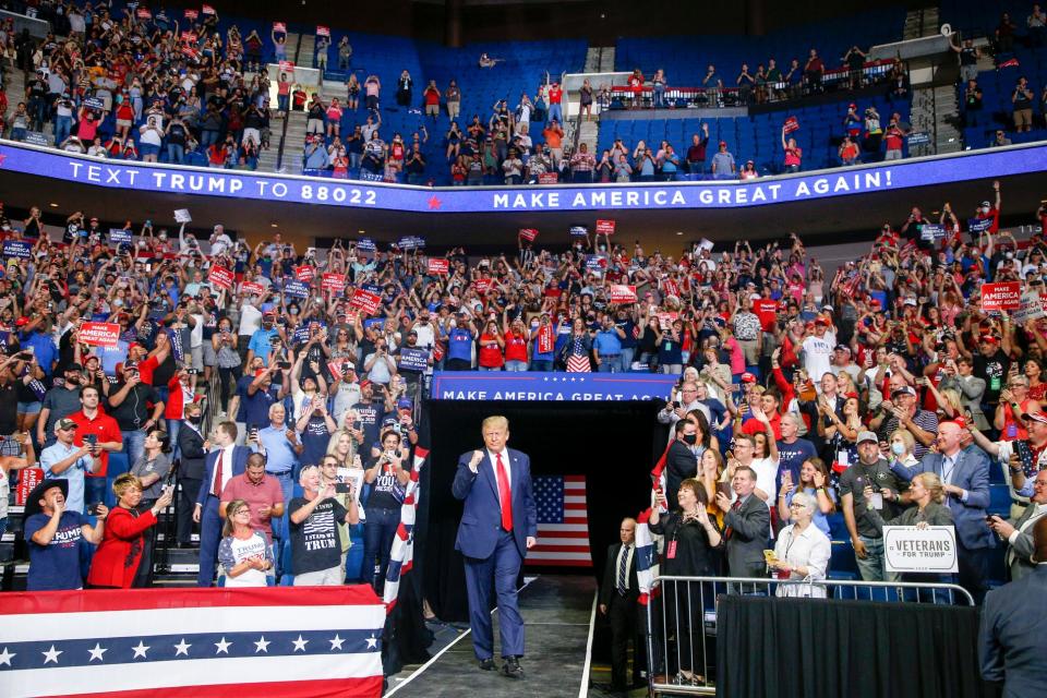 President Donald Trump greets cheering supporters at a campaign rally at the BOK Center in Tulsa, Okla., on June 20.