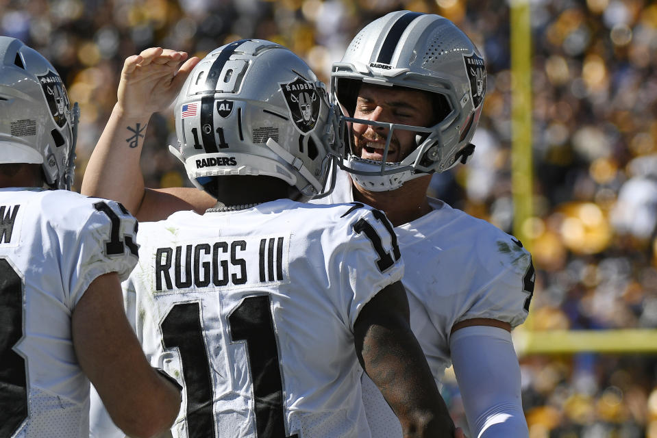 Las Vegas Raiders quarterback Derek Carr, right, celebrates a touchdown wide receiver Henry Ruggs III (11) during the second half of an NFL football game against the Pittsburgh Steelers in Pittsburgh, Sunday, Sept. 19, 2021. (AP Photo/Don Wright)