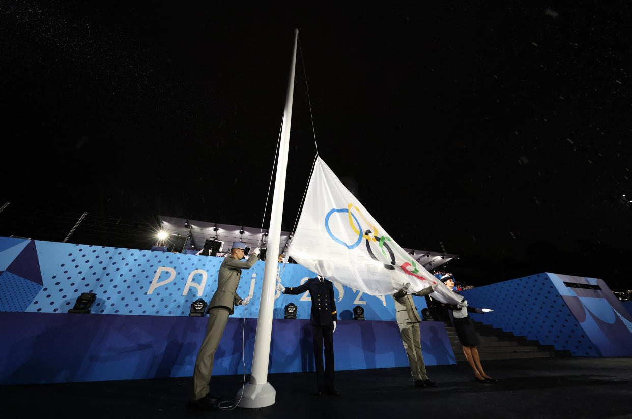 The Olympic Flag is raised at Place du Trocadero during the opening ceremony of the Olympic Games on Friday in Paris.