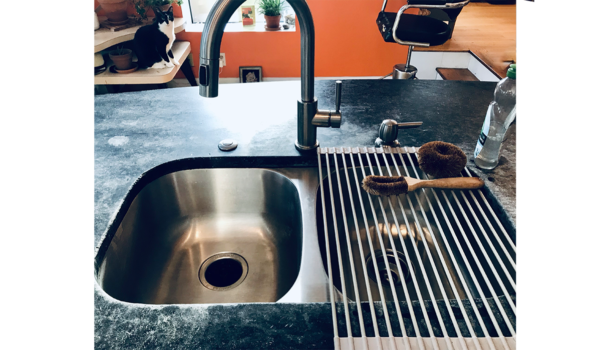 author's sink with a drying rack on one side