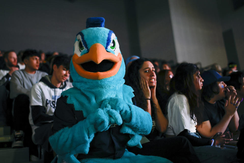 People react as they attend an on-campus watch party at Saint Peter's during the NCAA men's college basketball tournament game between Saint Peter's and North Carolina, Sunday, March 27, 2022, in Jersey City, N.J. (AP Photo/Eduardo Munoz Alvarez)