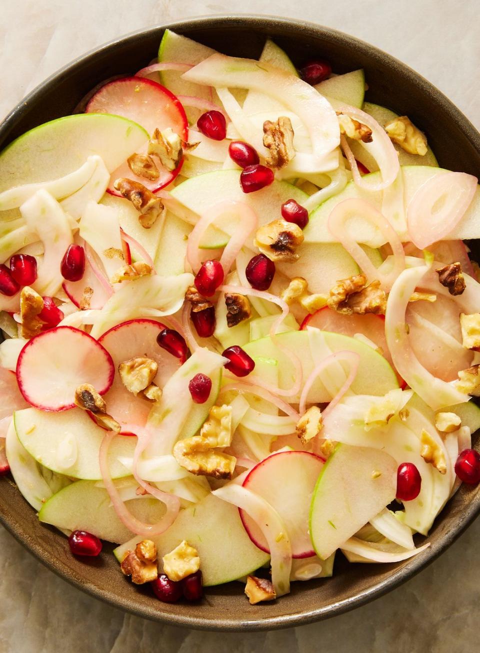 fresh fennel salad with apples, radishes, shallots, pomegranate seeds, and walnuts