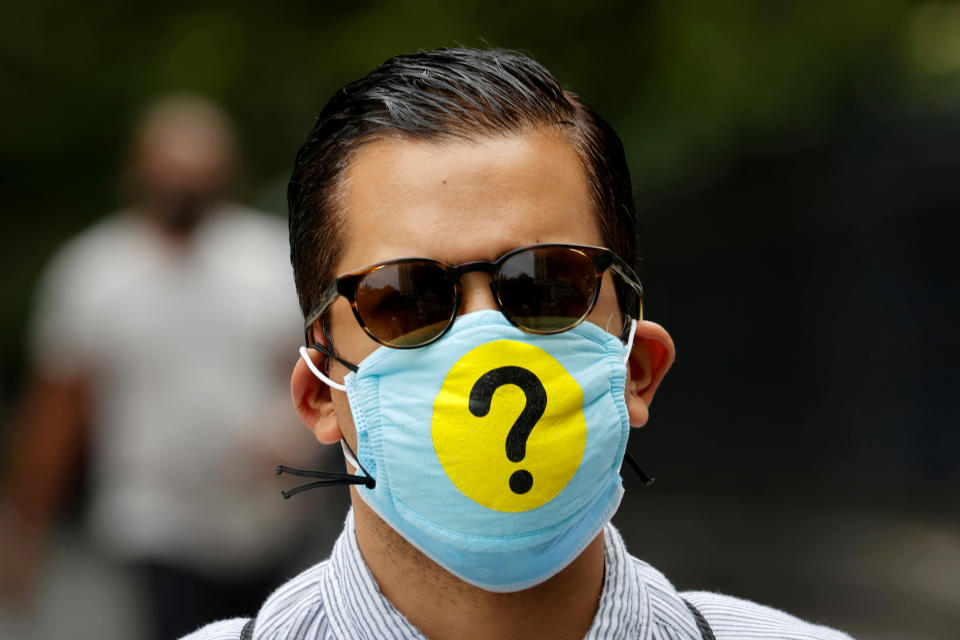 A man wears a protective face mask decorated with a question mark in lower Manhattan during the outbreak of the coronavirus disease (COVID-19) in New York, U.S., May 22, 2020. Picture taken May 22, 2020. REUTERS/Mike Segar     TPX IMAGES OF THE DAY