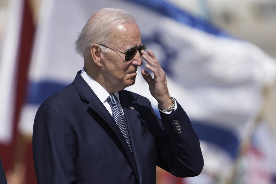 President Joe Biden adjusts his glasses during a welcoming ceremony upon his arrival at Ben Gurion International Airport near Tel Aviv, Israel Wednesday, July 13, 2022. Biden arrives in Israel on Wednesday for a three-day visit, his first as president. He will meet Israeli and Palestinian leaders before continuing on to Saudi Arabia. (AP Photo/Ariel Schalit)