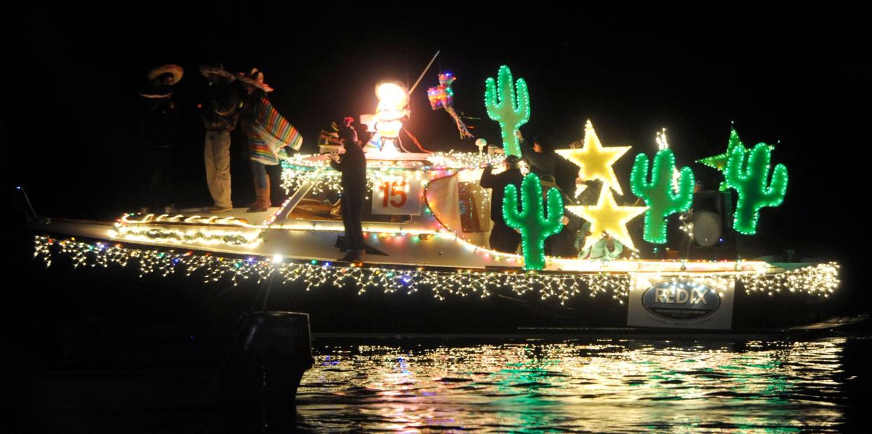 Boats strung with holiday lights float in Motts Channel at the 29th annual North Carolina Holiday Flotilla at Wrightsville Beach. This year's event is the 38th annual.