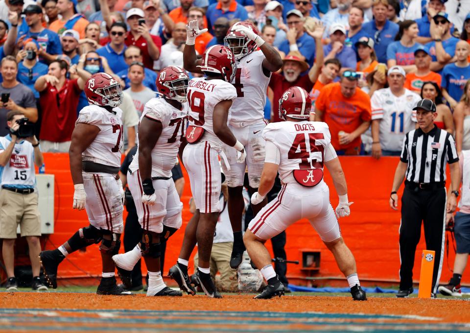 Alabama running back Brian Robinson Jr. is congratulated as he scores a touchdown during the second half against Florida at Ben Hill Griffin Stadium.