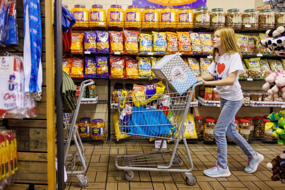 Maeve Scheler, 12, pushes a cart full of Utz items during a shopping spree for the Scheler family at the Utz Factory Outlet, Wednesday, Sept. 20, 2023, in Hanover.