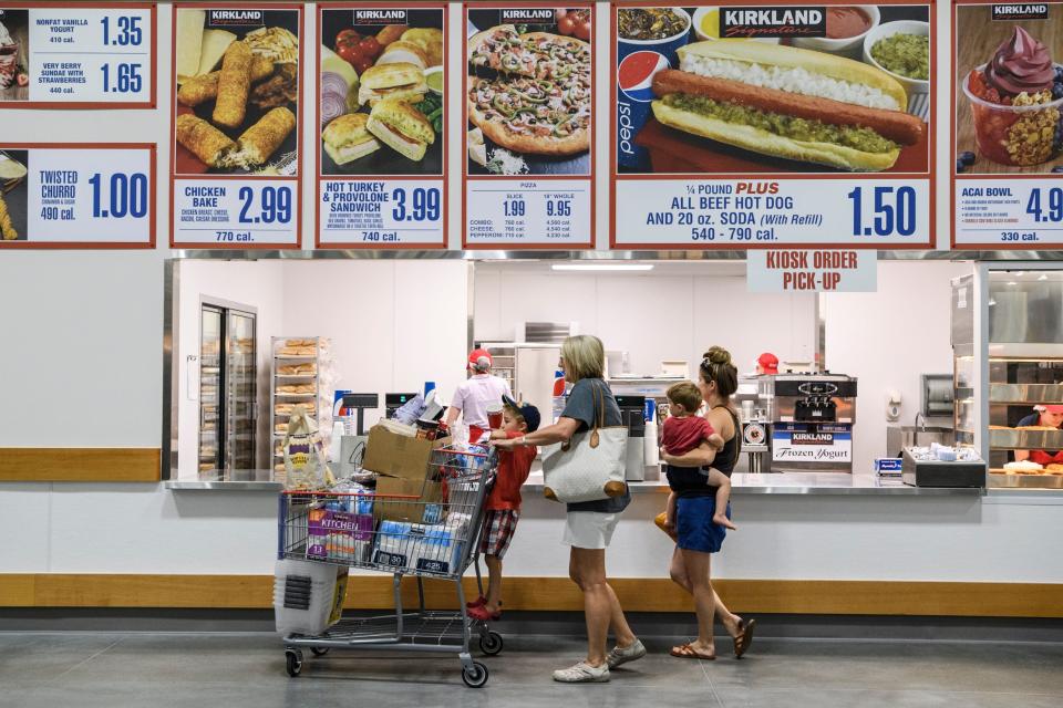 Jaxon Stern, 4, from left, Nicole Toone, Sawyer Stern, 2, and Victoria Stern order lunch at Costco's food court while shopping in the new Evansville store, Friday, June 28, 2019. They ordered a few 