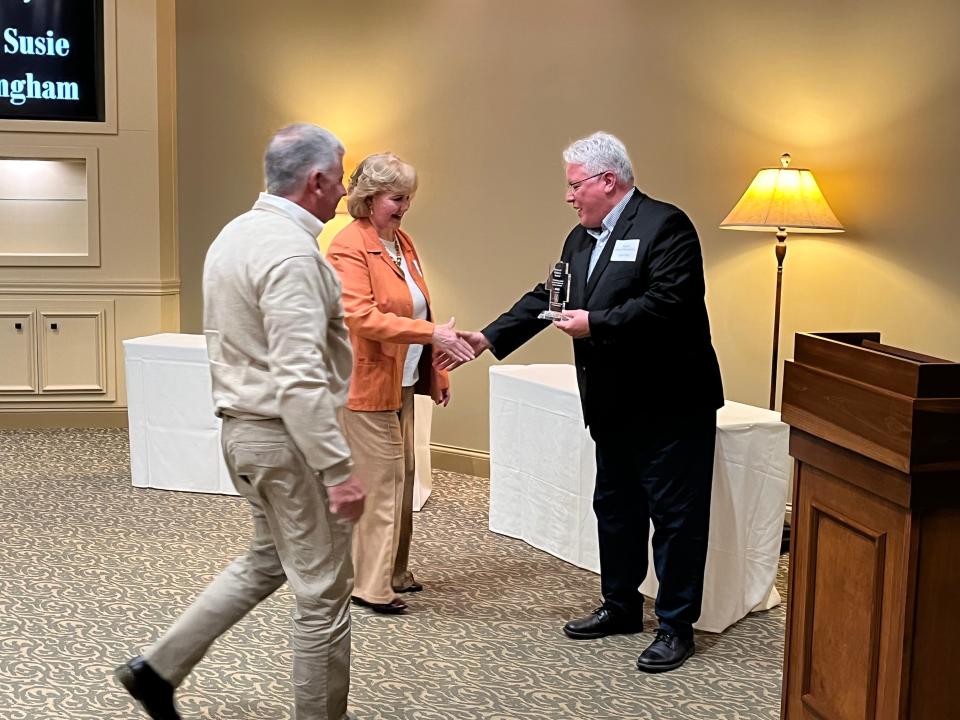 New Philadelphia Mayor Joel Day (Right) presents an award to Don and Susie Whittingham Thursday at the Heroes of Preservation and History ceremony at the Geib Funeral Center in Dover.
