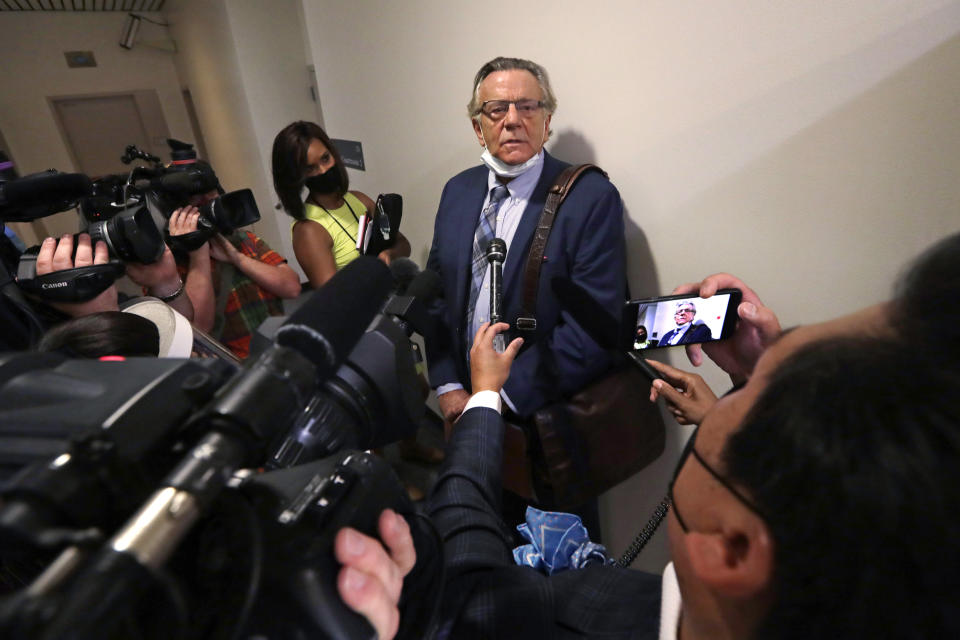 Attorney John Henry Browne speaks with media members after a court appearance by his client, Dawit Kelete, Monday, July 6, 2020, in Seattle. Kelete is accused of driving a car on to a closed Seattle freeway and hitting two protesters, killing one, over the weekend. Seattle has been the site of prolonged unrest over the death of George Floyd, a Black man who was in police custody in Minneapolis, and had shut down the interstate for 19 days in a row. (AP Photo/Elaine Thompson)