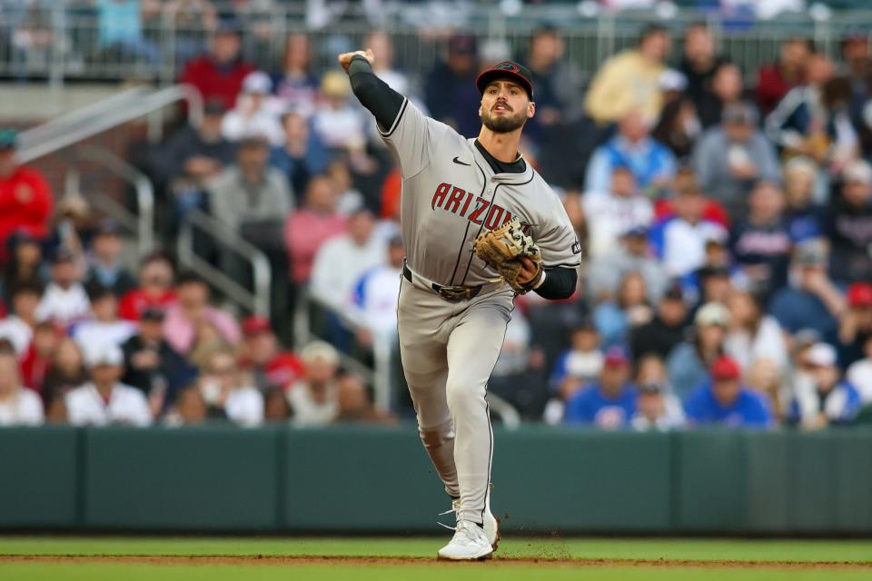 Arizona Diamondbacks shortstop Blaze Alexander (9) throws a runner out at first against the Atlanta Braves in the first inning at Truist Park.