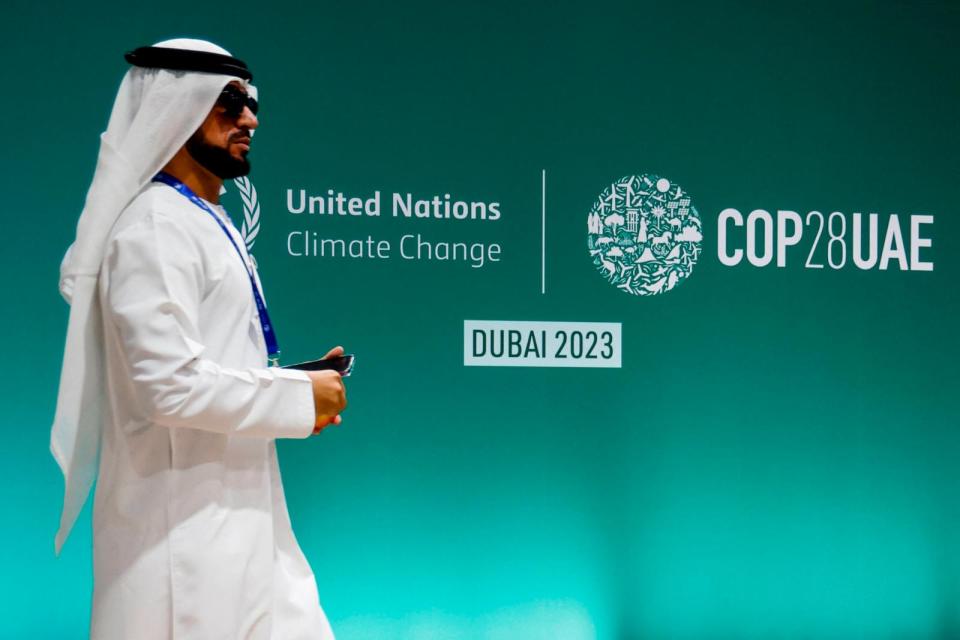 PHOTO:A man walks past a COP28 sign during the United Nations climate summit in Dubai, United Arab Emirates on Dec. 1, 2023.   (Ludovic Marin/AFP via Getty Images)