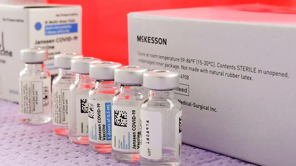 Bottles of the single-dose Johnson & Johnson Janssen COVID-19 vaccine await transfer into syringes.