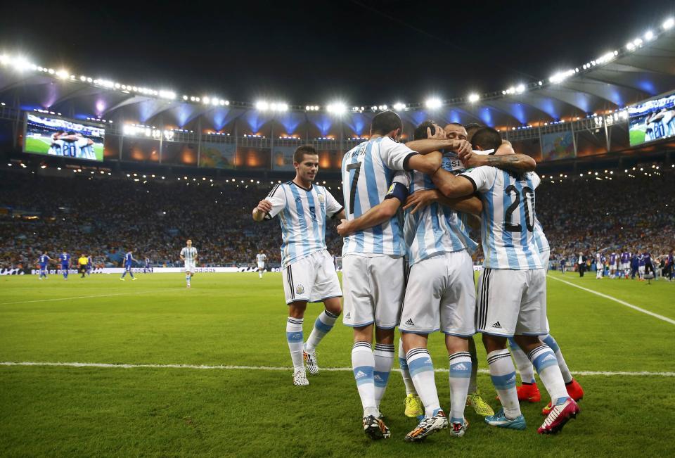 Argentina's Lionel Messi is congratulated by his teammates after scoring a goal against Bosnia during their 2014 World Cup Group F soccer match at the Maracana stadium in Rio de Janeiro June 15, 2014. REUTERS/Michael Dalder (BRAZIL - Tags: SOCCER SPORT WORLD CUP)