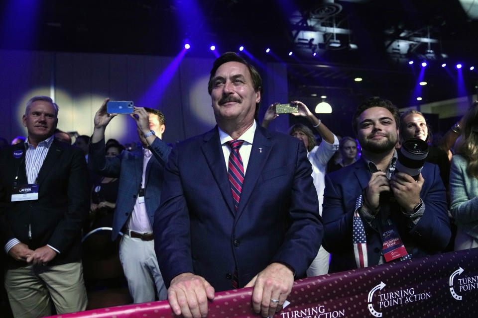 Mike Lindell, CEO of My Pillow, listens as former President Donald Trump speaks at the Turning Point Action conference, Saturday, July 15, 2023, in West Palm Beach, Fla. (AP Photo/Lynne Sladky)