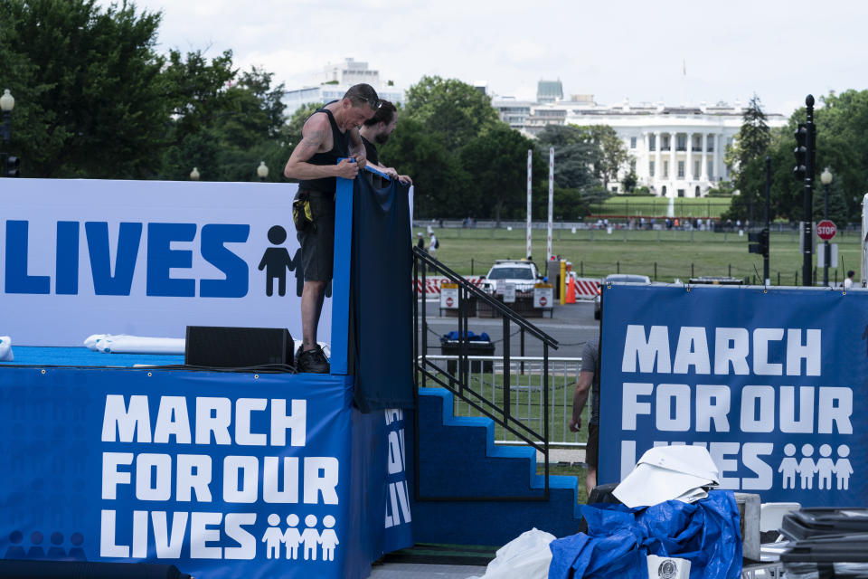 Workers set up for the March for Our Lives rally on the National Mall, near the White House, in Washington, Friday, June 10, 2022. The march is returning to Washington after four years. (AP Photo/Alex Brandon)