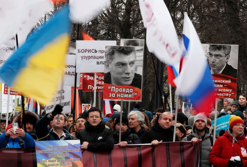 People take part in a rally to mark the 5th anniversary of Russian opposition politician Boris Nemtsov's murder and to protest against proposed amendments to the country's constitution, in Moscow