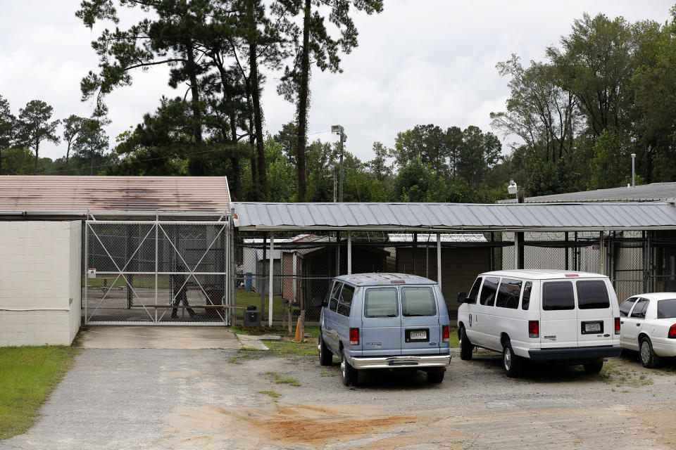 A Hampton County official walks to the county jail before the bond hearing for Alex Murdaugh Thursday, Sept. 16, 2021, in Varnville, S.C. Lawyer Alex Murdaugh surrendered Thursday to face insurance fraud and other charges after state police said he arranged to have himself shot in the head so that his son would get a $10 million life insurance payout. (AP Photo/Mic Smith)