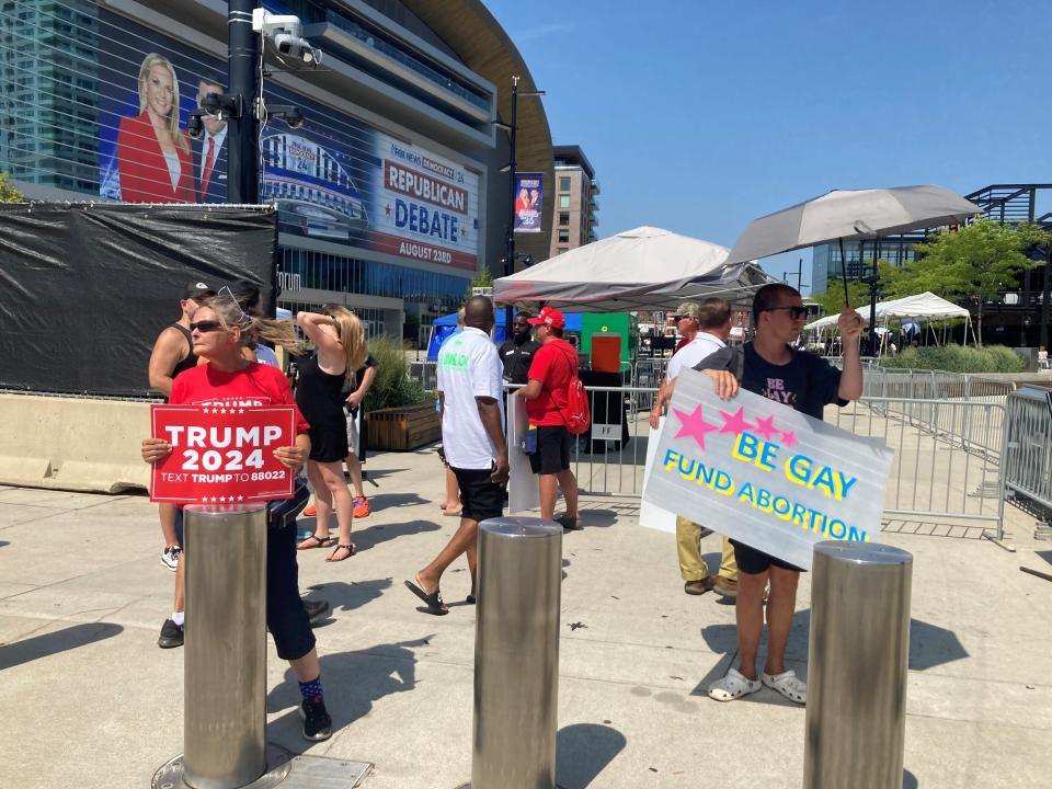 Few people ventured outside in the heat Wednesday afternoon, but some held signs near Fiserv Forum.