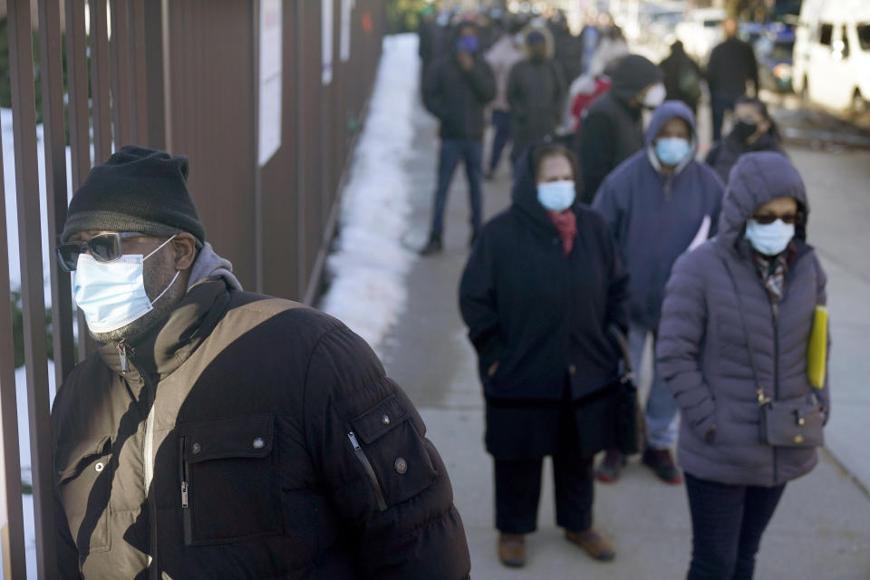 People wait in line to get vaccinated at a mass COVID-19 vaccination site in the Queens borough of New York, Wednesday, Feb. 24, 2021. This FEMA run site, along with another in Brooklyn, gives priority to local residents in an effort to equitably distribute the vaccine. (AP Photo/Seth Wenig, Pool)