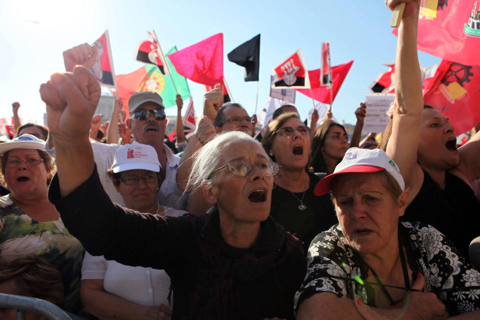 Protestors shout slogans at Lisbon's Comercio Square during a workers unions' demonstration, Saturday, Sept. 29 2012. Thousands of Portuguese enduring deep economic pain from austerity cuts took to the streets Saturday in protest. (AP Photo/Joao Henriques)