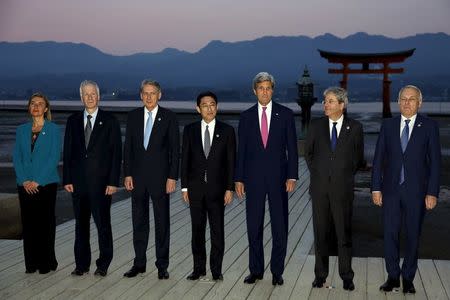 E.U. High Representative for Foreign Affairs Federica Mogherini, Canada's Foreign Minister Stephane Dion, Britain's Foreign Minister Philip Hammond, Japan's Foreign Minister Fumio Kishida, U.S. Secretary of State John Kerry, Italy's Foreign Minister Paolo Gentiloni and France's Foreign Minister Jean-Marc Ayrault (L-R) take a family photo at the Itsukushima Shrine as they take a cultural break from their G7 Foreign Minister meetings in nearby Hiroshima to visit Miyajima Island, Japan, April 10, 2016. REUTERS/Jonathan Ernst