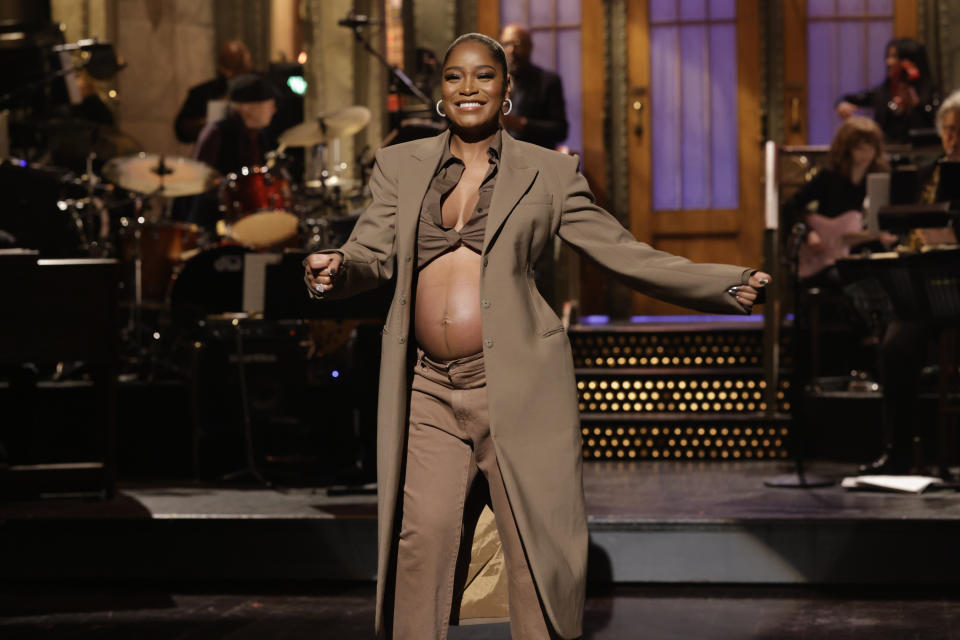 This image released by NBC shows host Keke Palmer revealing her pregnancy during her monologue on "Saturday Night Live" in New York on Dec. 3, 2022. (Will Heath/NBC via AP)