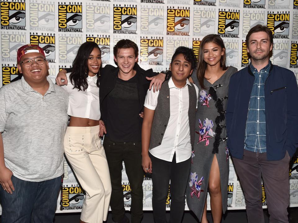 SAN DIEGO, CA - JULY 23: (L-R) Actors Jacob Batalon, Laura Harrier, Tom Holland, Tony Revolori, Zendaya and director Jon Watts from Marvel Studios’ "Spider-Man: Homecoming” attend the San Diego Comic-Con International 2016 Marvel Panel in Hall H on July 23, 2016 in San Diego, California.