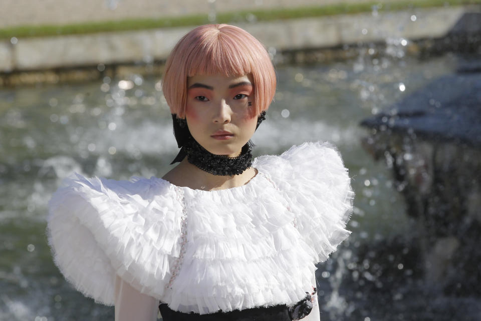 A model presents a creation by German fashion designer Karl lagerfeld for Chanel Monday, May, 14, 2012. Master of Fashion, Karl Lagerfeld spares no expenses for his midseason Chanel Cruise show offering held at the former home of Marie Antoinette, the Chateau de Versailles, southwest of Paris. (AP Photo/Jacques Brinon)