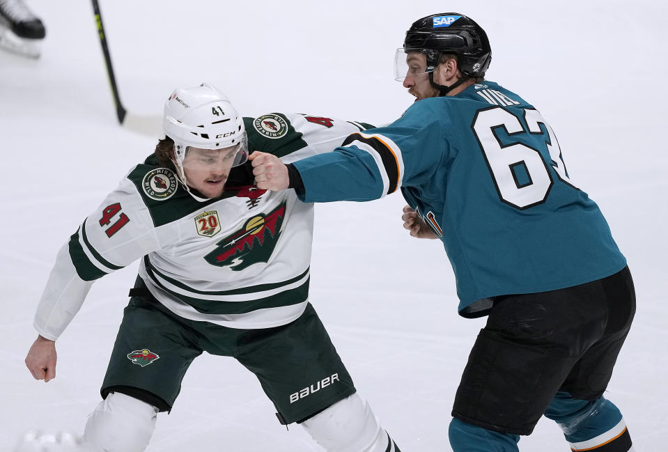 Minnesota Wild center Luke Johnson (41) fights with San Jose Sharks left wing Jeffrey Truchon-Viel (63) during the first period of an NHL hockey game in San Jose, Calif., Monday, March 29, 2021. (AP Photo/Tony Avelar)