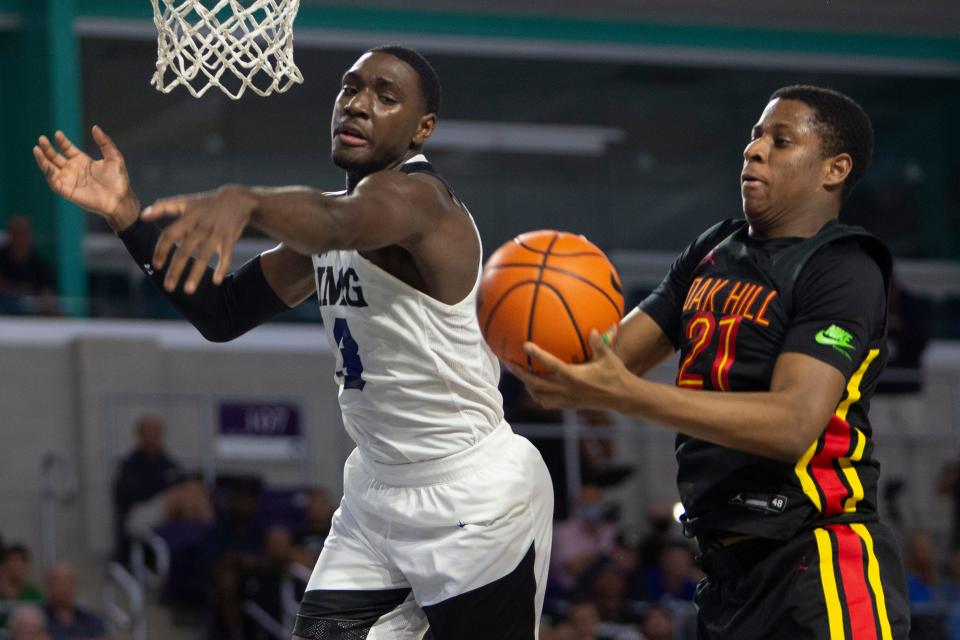 Justn McBride, right, grabs a rebound in 2021 while a member of Oak Hill Academy. He committed to Oklahoma State on Wednesday. McBride, a four-star power forward, moved back to Plano (Texas) High after two years with the prep school.