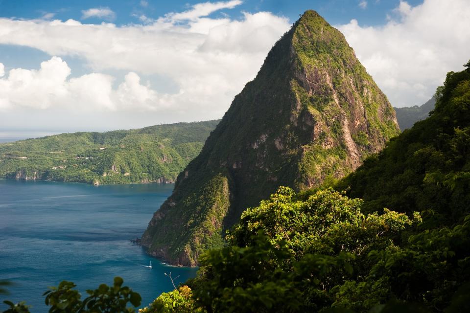 View of jagged Petit Piton jutting out of the blue Caribbean Sea as viewed from the slopes of neighbouring Gros Piton, near Soufriere Saint Lucia.