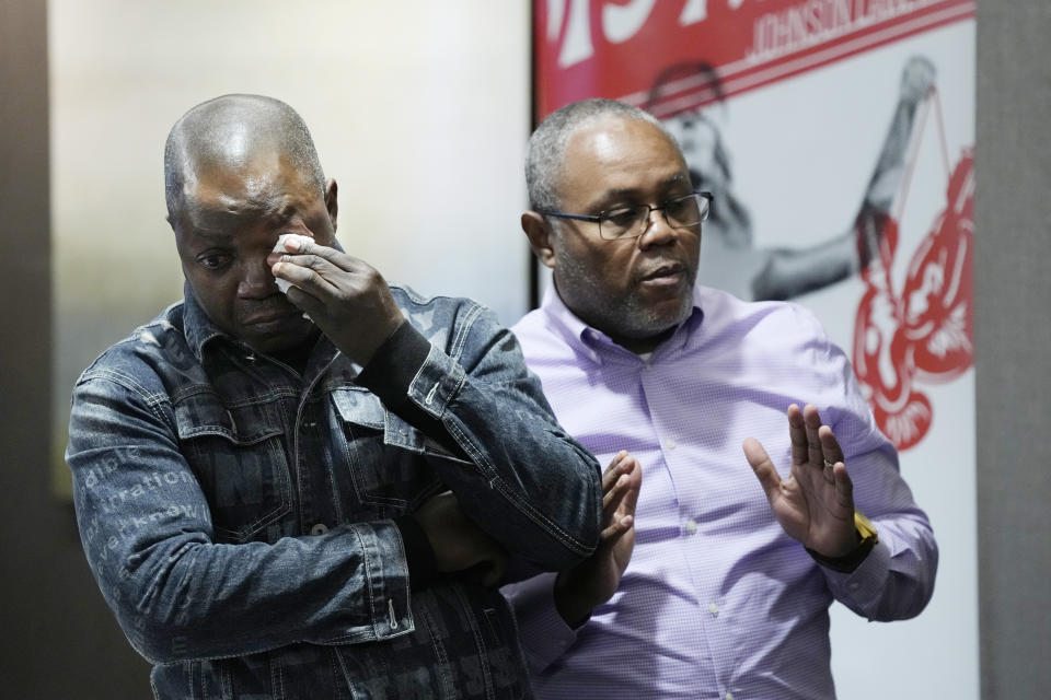 Peter Lyoya wipes his eye as he listens to his family interpreter as he looks at video of his son's shooting during a news conference, Wednesday, Dec. 7, 2022, in Detroit. The family of Patrick Lyoya, a Black motorist fatally shot by a white police officer in Grand Rapids, Mich., filed a lawsuit Wednesday in federal court against the now-former officer and the city of Grand Rapids. The civil rights suit on behalf of Lyoya's family alleges unnecessary, illegal and excessive force and gross negligence by then-Officer Christopher Schurr. (AP Photo/Carlos Osorio)