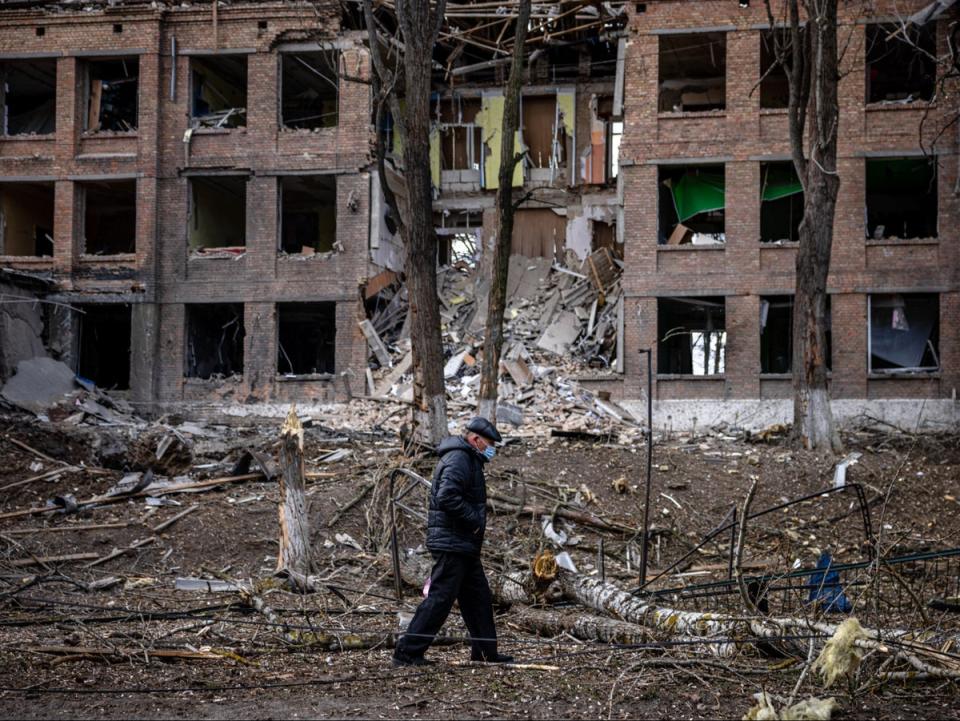 A man walks in front of a destroyed building after a Russian missile attack in the town of  Vasylkiv, near Kyiv, on 27 February (AFP/Getty)