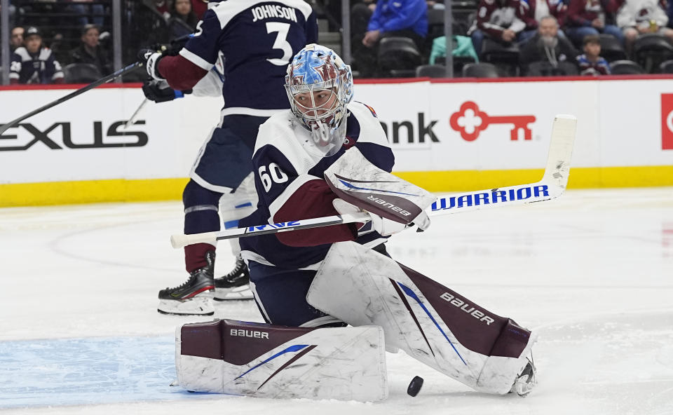 Colorado Avalanche goaltender Justus Annunen, foreground, makes pad-save of a shot in the second period of an NHL hockey game against the Winnipeg Jets, Saturday, April 13, 2024, in Denver. (AP Photo/David Zalubowski)