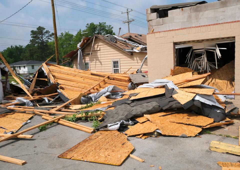 Debris from several roofs is part of the tornado aftermath near Main Street and Etowah in Noble.