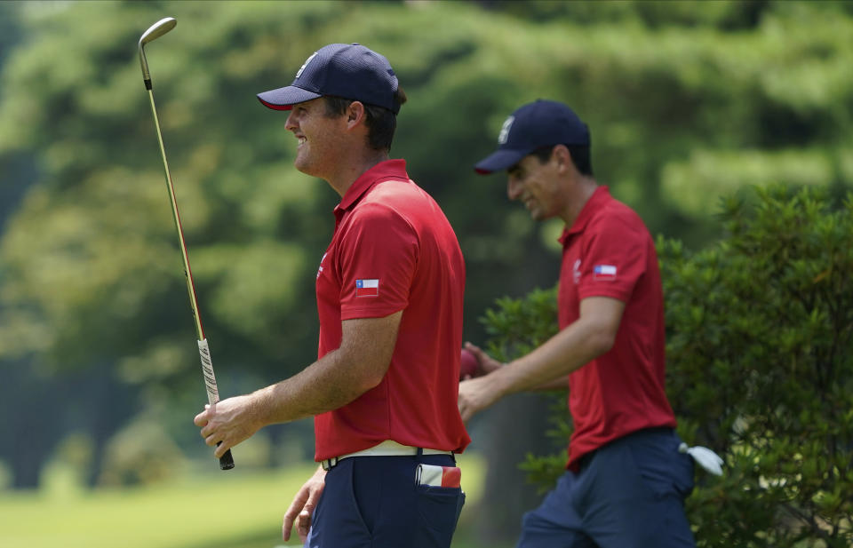 Chile's Mito Pereira, left, speaks with his teammate Joaquin Niemann during a practice round of the men's golf event at the 2020 Summer Olympics, Tuesday, July 27, 2021, at the Kasumigaseki Country Club in Kawagoe, Japan, (AP Photo/Matt York)