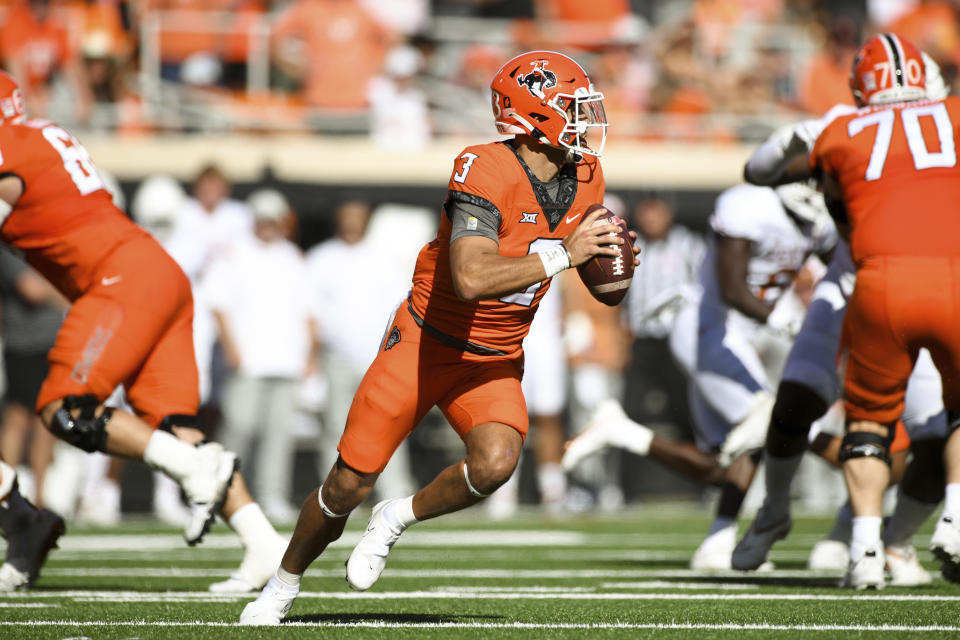 Oklahoma State quarterback Spencer Sanders (3) scrambles during the first half of an NCAA college football game against Texas, Saturday, Oct. 22, 2022, in Stillwater, Okla.(AP Photo/Brody Schmidt)