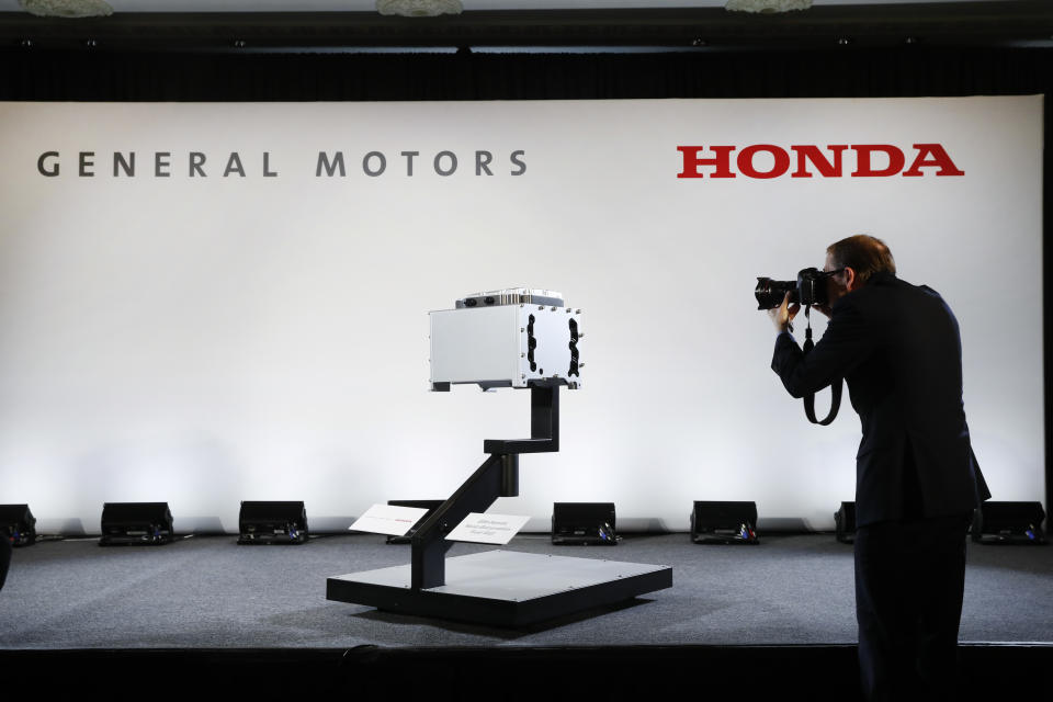 FILE -In this Jan. 30, 2020 file photo, a photographer captures images of the General Motors-Honda Next Generation Fuel Cell after a news conference in Detroit. On Thursday, Sept. 3, General Motors and Honda say they have signed a deal to explore sharing vehicle underpinnings and propulsion systems in North America. The companies say planning discussions on jointly designed vehicles will start immediately and include vehicles powered by both electricity and internal combustion engines. (AP Photo/Paul Sancya)