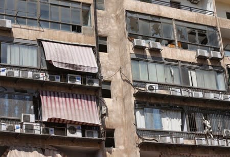 Broken windows are pictured after an Israeli drone fell in the Hezbollah-dominated southern suburbs and a second one exploded near the ground in Dahiyeh suburbs of Beirut