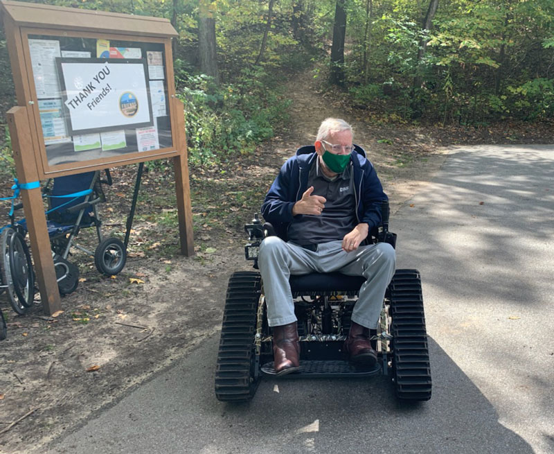 Ric Edwards tests an Action Track Chair at Potato Creek State Park.
