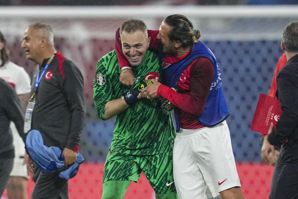 Turkey's goalkeeper Mert Gunok gets a hug after a round of sixteen match between Austria and Turkey at the Euro 2024 soccer tournament in Leipzig, Germany, Tuesday, July 2, 2024. (AP Photo/Andreea Alexandru)