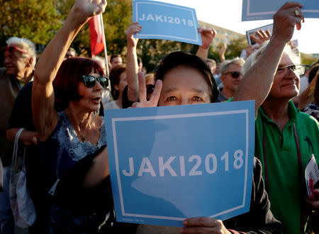 A supporter of Patryk Jaki, United Right (Law and Justice (PiS), Solidarna Prawica and Polska Razem) candidate for mayor in Warsaw, holds a banner during an election meeting in Warsaw, Poland September 19, 2018. REUTERS/Kacper Pempel/File Photo