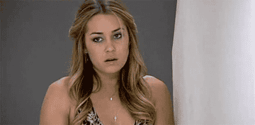 Lauren Conrad in a reflective pose, wearing a sleeveless, patterned top, with loose, wavy hair. Facial expression appears thoughtful