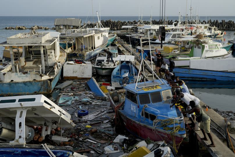 Fishermen push a boat damaged by Hurricane Beryl at the Bridgetown fisheries, Barbados, Tuesday, 2 July, 2024.