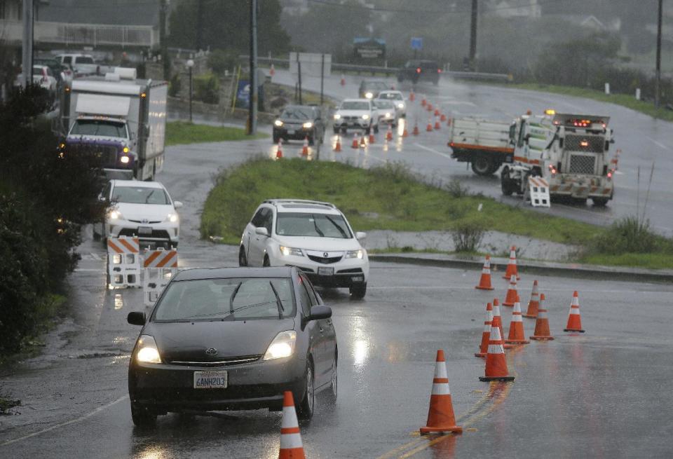 Traffic is diverted around flooded areas Thursday, Dec. 15, 2016, in Mill Valley, Calif. One of the strongest rainstorms of the season hit the San Francisco Bay Area on Thursday, with a small town in the North Bay receiving nearly seven inches of rain over the last 24-hour period, forecasters said. Flash-flood warnings are in effect for southern Sonoma County and northern Marin County. (AP Photo/Eric Risberg)