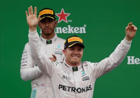 Formula One - F1 - Italian Grand Prix 2016 - Autodromo Nazionale Monza, Monza, Italy - 4/9/16 Mercedes' Nico Rosberg celebrates his win on the podium after the race as Lewis Hamilton looks on Reuters / Max Rossi Livepic